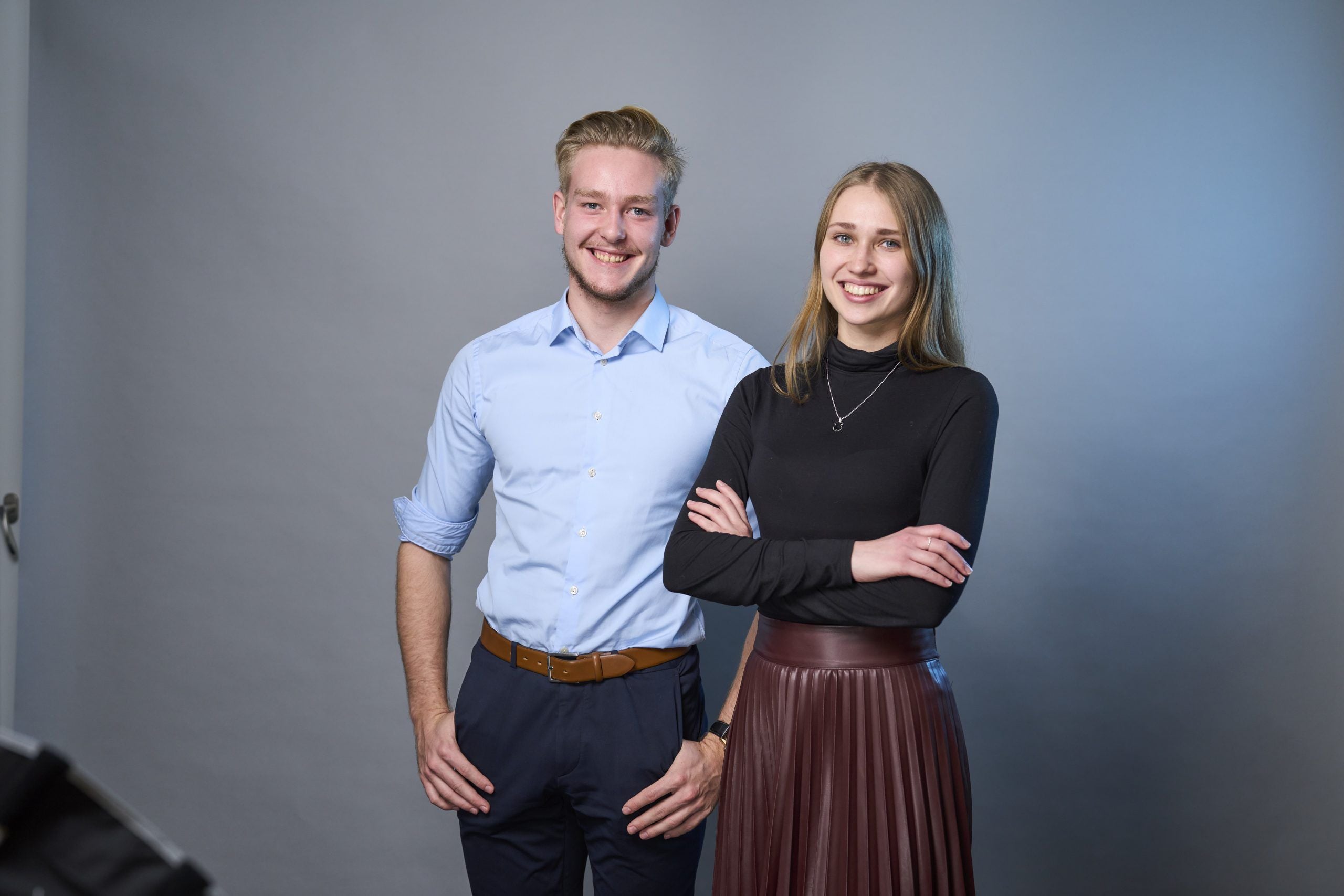 Two graduate consultants looking into the camera