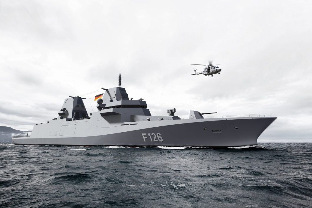 Military ship sailing on the sea in black and white, displaying a German flag