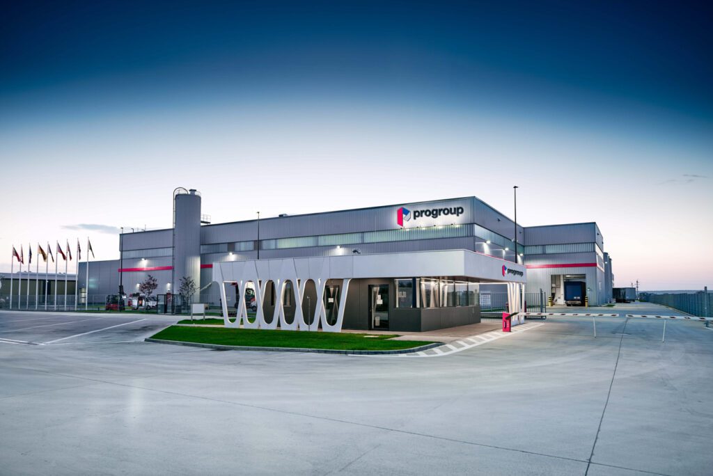 Modern industrial facility with Progroup logo and flags – HZ Group consulting industrial process optimization