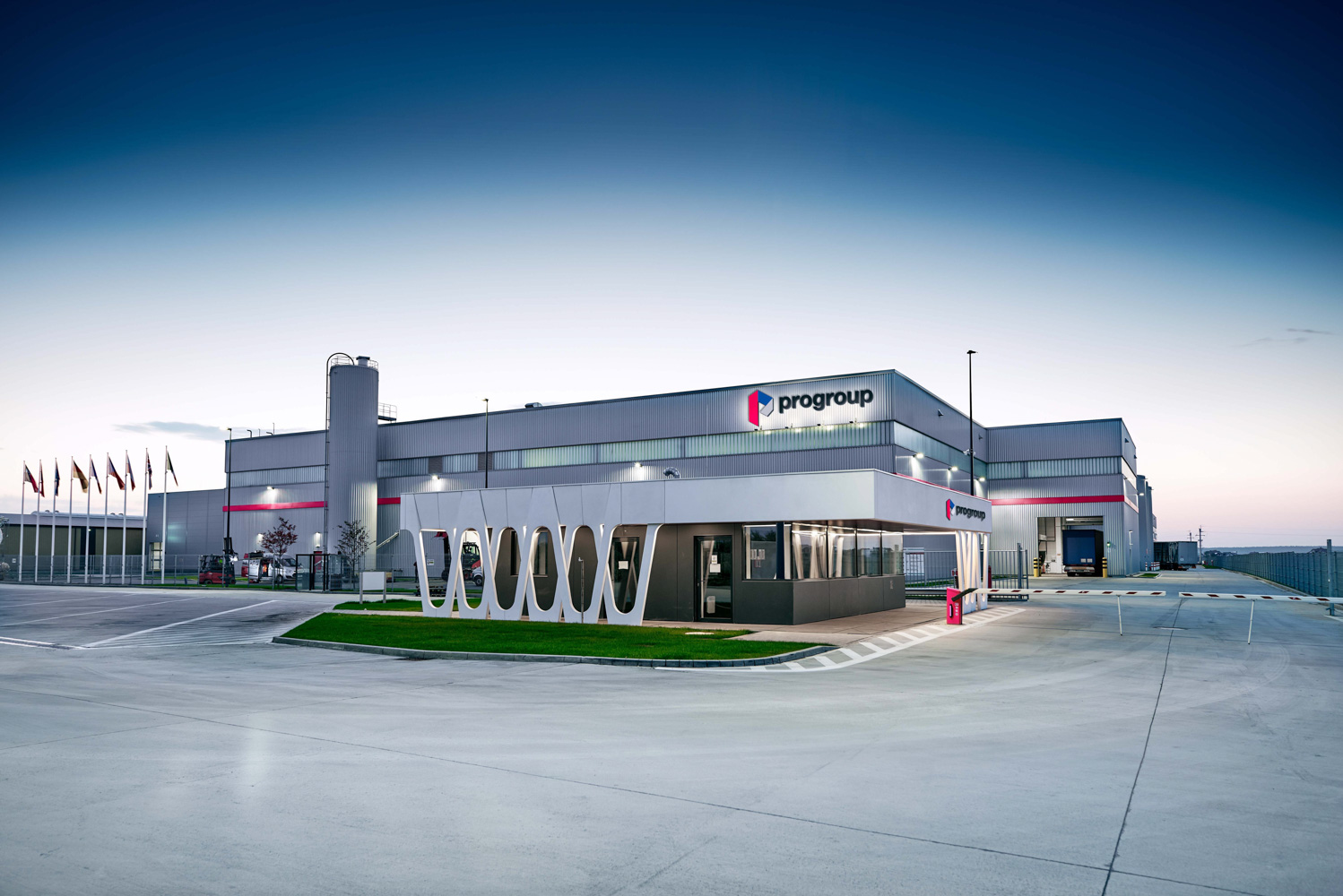 Modern industrial facility with Progroup logo and flags – HZ Group consulting industrial process optimization