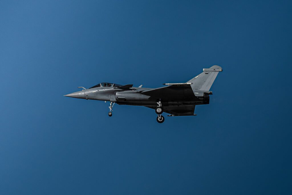 Jet fighter aircraft in flight against a clear blue sky, symbolizing the aerospace industry and defense sector insights relevant to strategic consulting and procurement.