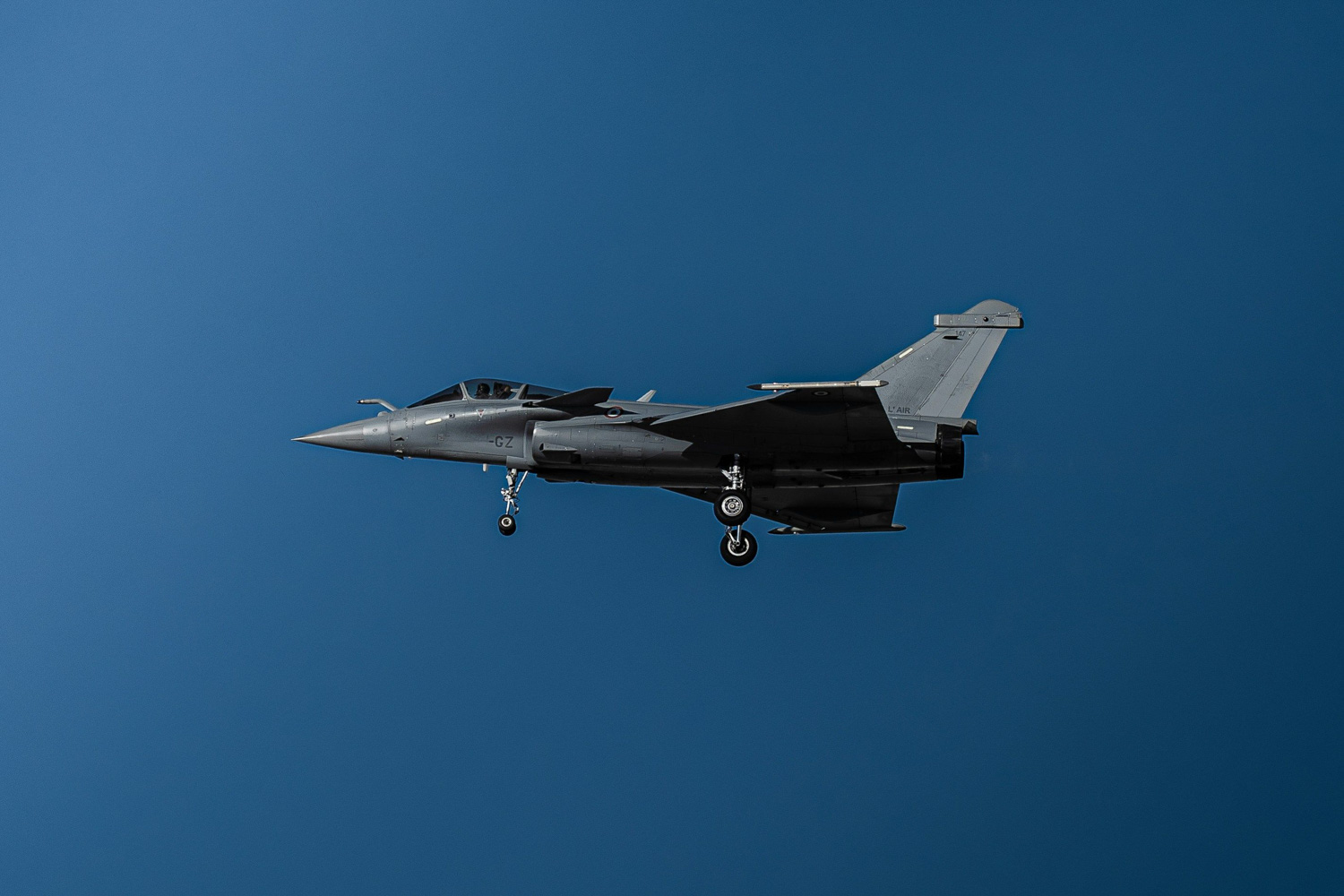 Jet fighter aircraft in flight against a clear blue sky, symbolizing the aerospace industry and defense sector insights relevant to strategic consulting and procurement.