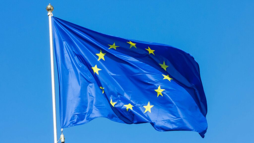 European Union flag waving in the wind, symbolizing international cooperation and regulatory frameworks relevant to consulting strategies