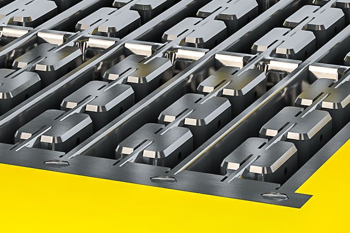 Close-up of metallic industrial mold components arranged in precise rows with a bright yellow background, symbolizing precision manufacturing, engineering quality and commercial due diligence insights for strategic consulting.