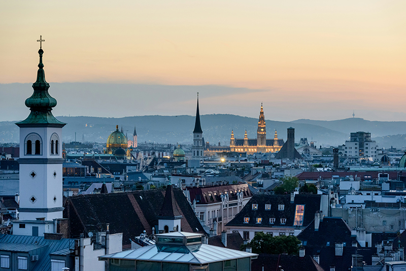 Cityscape of Vienna at twilight with spires and historic rooftops, representing an urban landscape inspiring innovative solutions and strategic thinking in consulting projects.
