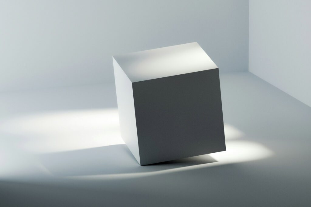 Minimalist white cube on a smooth surface with soft lighting symbolizing clarity and solid solutions in consulting services.