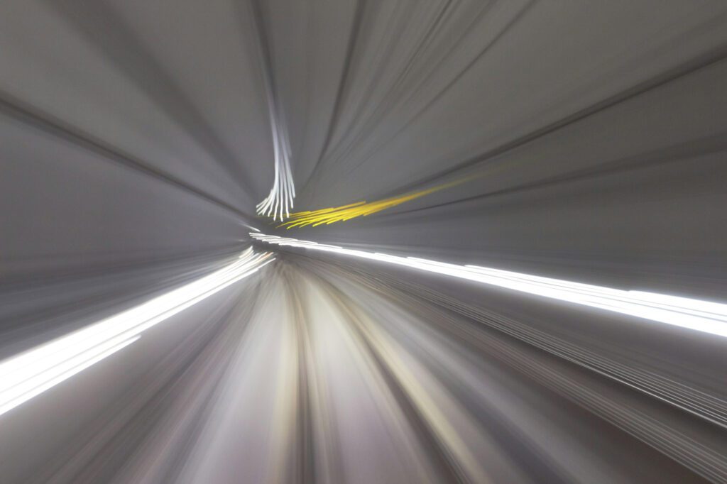 Abstract motion blur inside a tunnel representing speed and dynamics of process and software implementation in consulting projects.