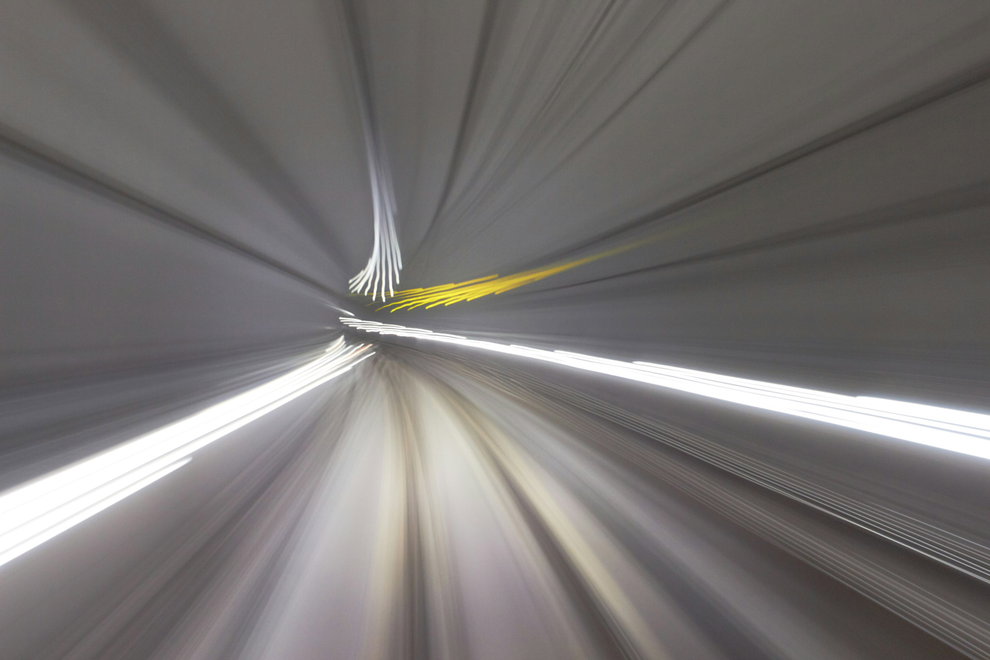 Abstract motion blur inside a tunnel representing speed and dynamics of process and software implementation in consulting projects.