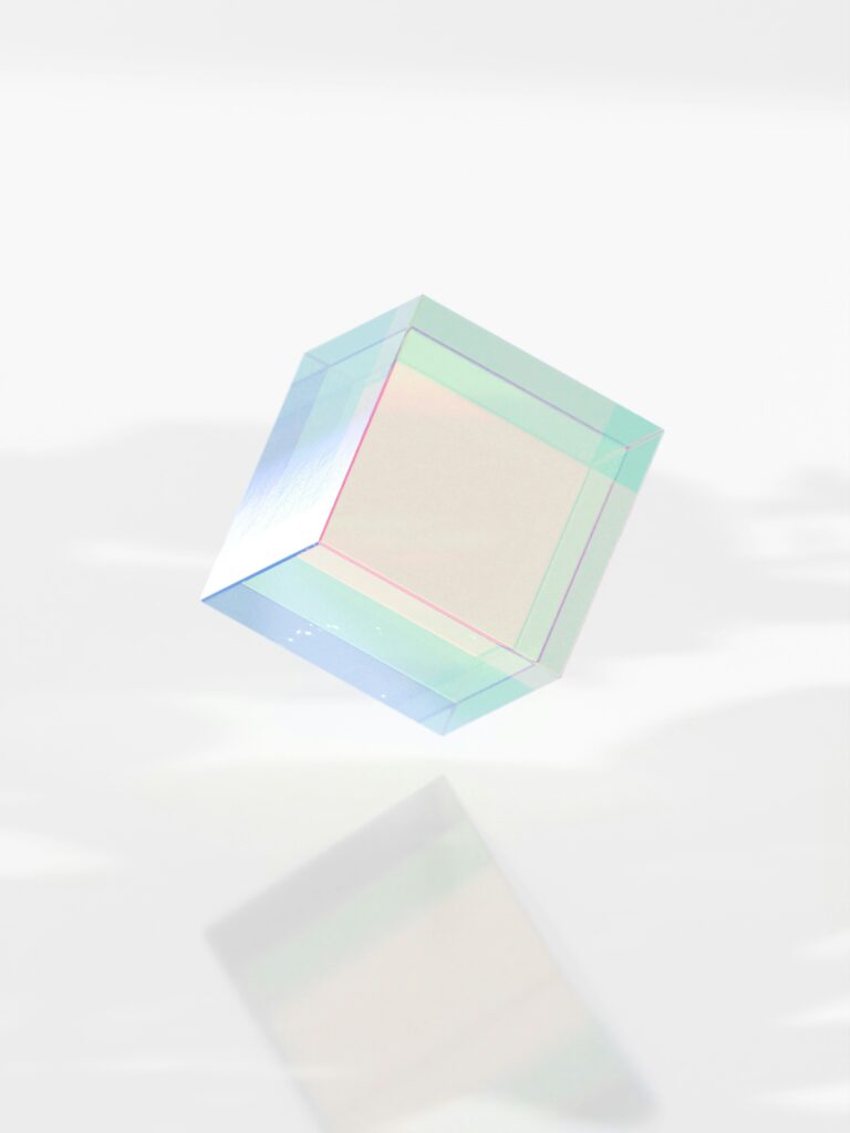 Translucent pastel-colored cube floating against a light background, symbolizing clarity, creativity and balanced problem-solving in consulting projects.