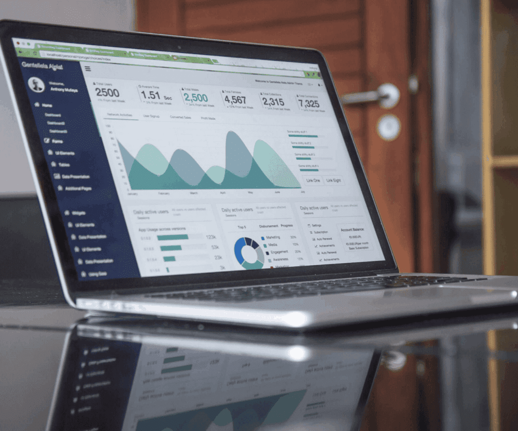 Open laptop displaying a data analytics dashboard with charts, graphs and metrics, representing performance analysis and strategic insights for consulting services.