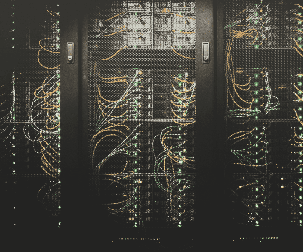Server racks filled with networking cables and blinking lights in a data center, representing IT infrastructure and digital transformation in consulting.