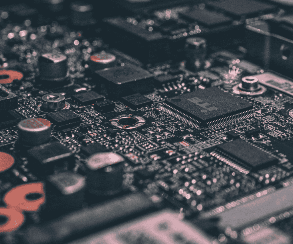 Macro photo of an electronic motherboard with chips and capacitors, highlighting technological complexity and hardware infrastructure for digital innovation in consulting.
