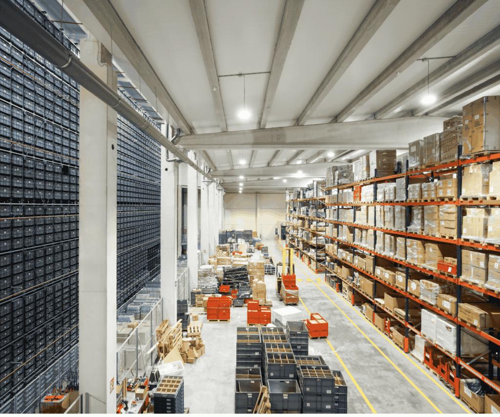 Warehouse interior with shelves stacked with boxes and pallets, symbolizing supply chain logistics for business consulting.