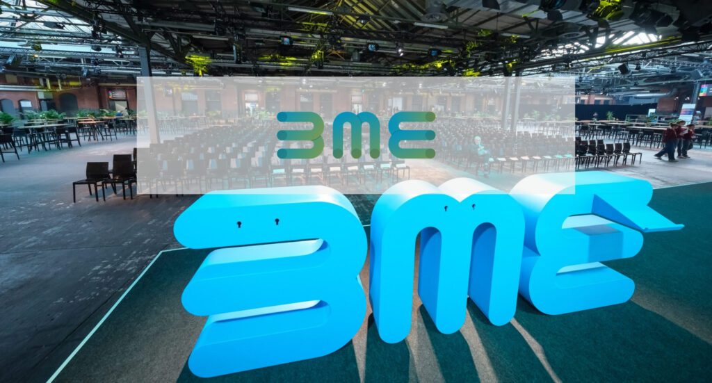 Large blue BME letter installations on stage at a procurement association event | H&Z