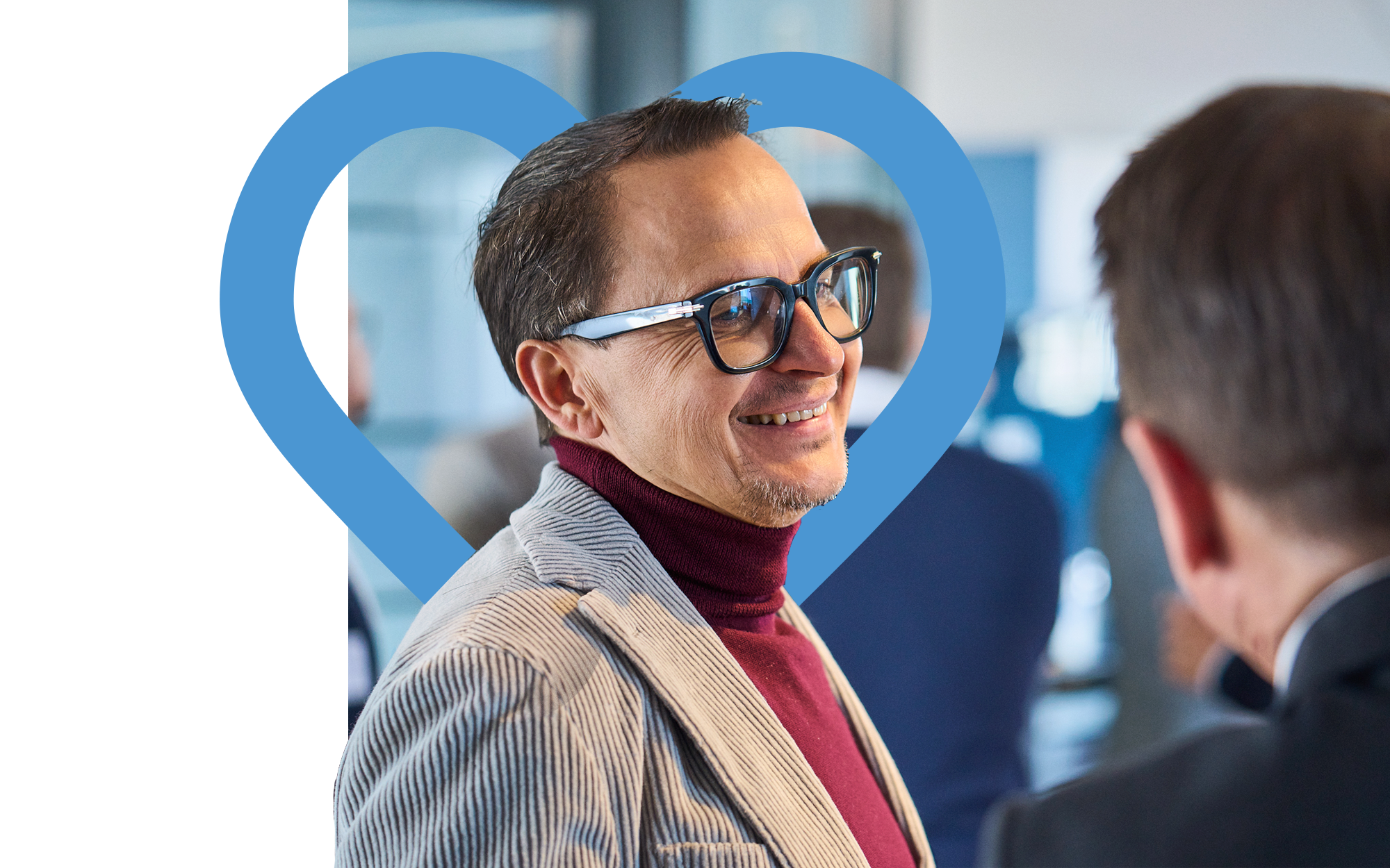 Stefan Herz in conversation, framed by the blue H&Z Heart brand icon | H&Z