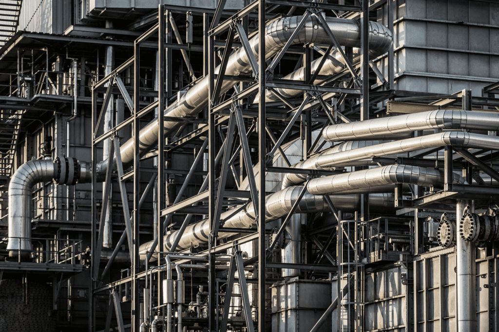 Complex insulated piping system and steel framework inside an industrial plant | H&Z