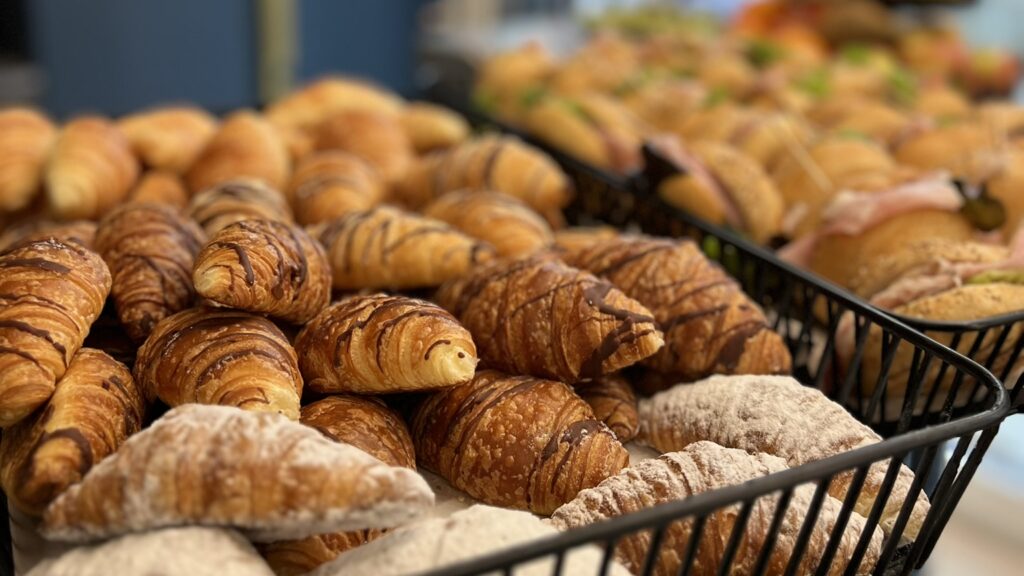 Breakfast foods, fresh croissants and sandwiches with deli meats and
