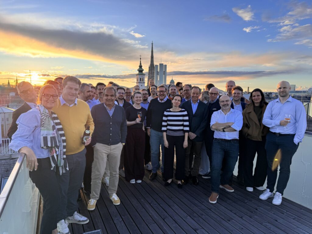 H&Z team on a Vienna rooftop terrace at sunset, marking recognition in the 2026 Handelsblatt consulting rankings | H&Z