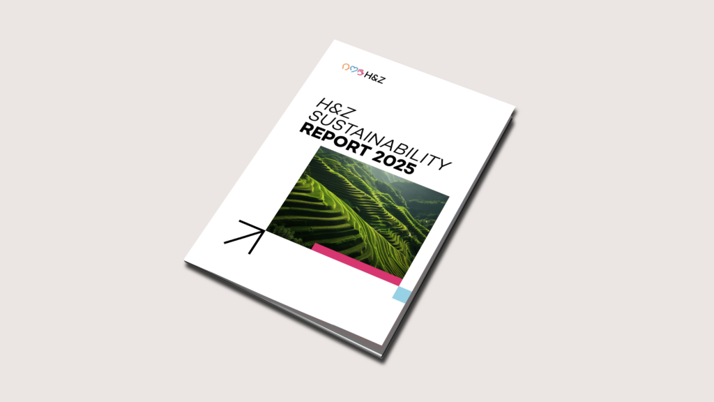 Mockup of the H&Z Sustainability Report 2025: the printed report with its green terraced-fields cover, angled on a light background.
